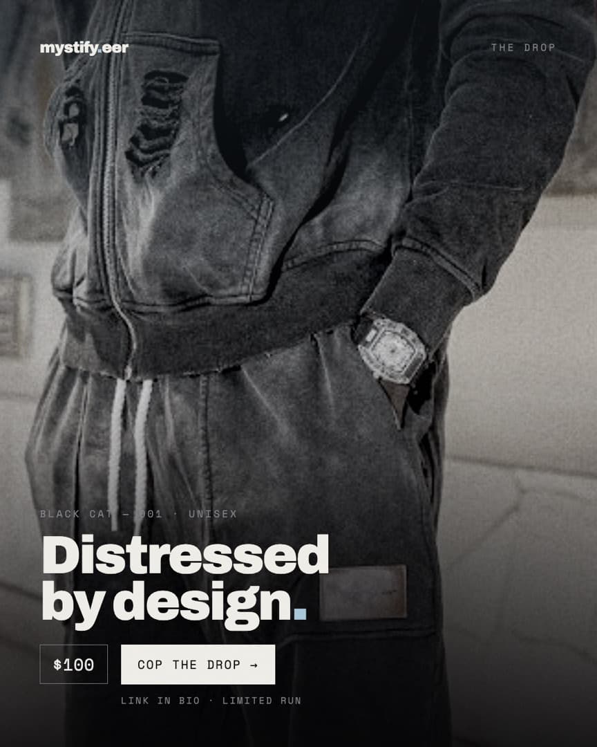 Close crop of the Black Cat 001 distressed hoodie and trousers with a watch at the cuff, headline Distressed by design