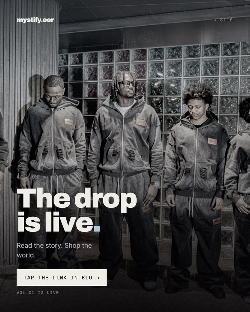 Four models in matching washed-black mystify.eer hoodies and trousers against a glass-block wall, captioned The drop is live